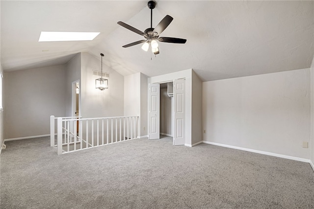 bonus room featuring carpet floors, visible vents, lofted ceiling with skylight, ceiling fan, and baseboards