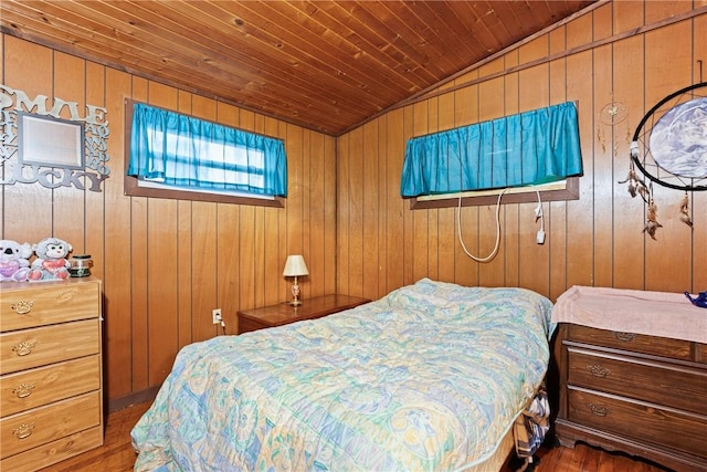 bedroom with wood walls, wood ceiling, vaulted ceiling, and wood finished floors