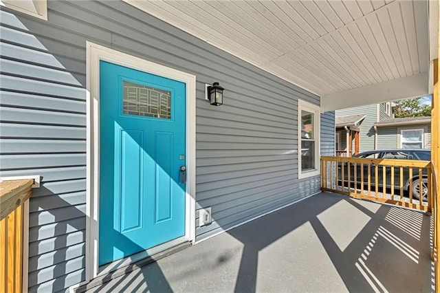 view of exterior entry with covered porch