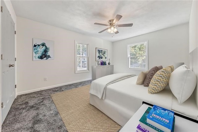 carpeted bedroom featuring ceiling fan and baseboards