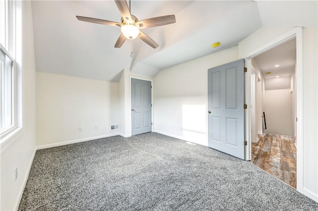 bonus room with carpet, visible vents, vaulted ceiling, and baseboards