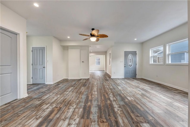 interior space featuring baseboards, dark wood finished floors, and recessed lighting