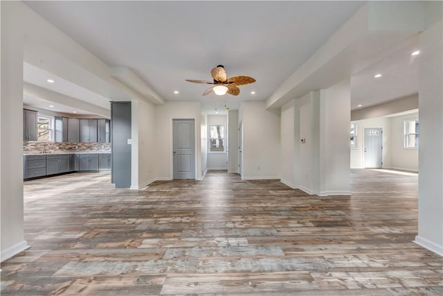 spare room with wood finished floors, a wealth of natural light, and recessed lighting