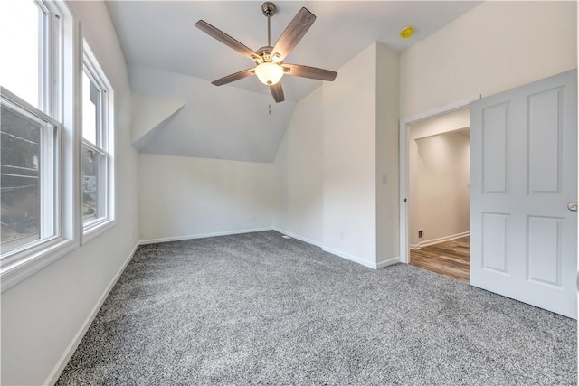 bonus room with vaulted ceiling, carpet, a ceiling fan, and baseboards