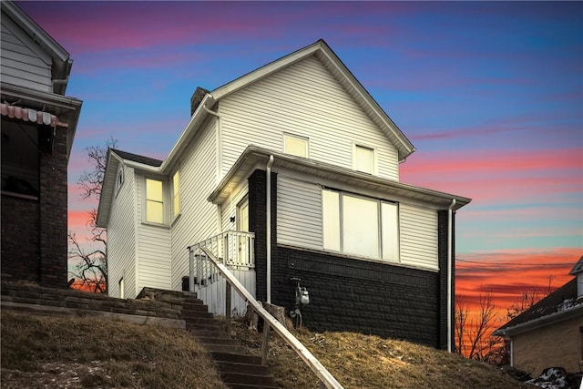 exterior space featuring stairs and brick siding