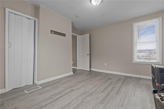 1155 6th Ave, Freedom, PA 15042 - unfurnished living room with light wood finished floors, visible vents, and baseboards