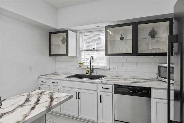 1155 6th Ave, Freedom, PA 15042 - kitchen with glass insert cabinets, appliances with stainless steel finishes, light stone counters, a sink, and decorative backsplash