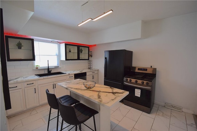1155 6th Ave, Freedom, PA 15042 - kitchen featuring tasteful backsplash, white cabinetry, black appliances, marble finish floor, and a sink