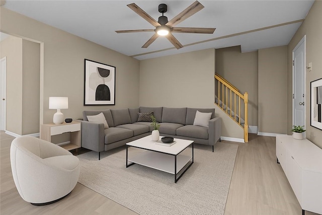 1155 6th Ave, Freedom, PA 15042 - living area with stairs, light wood finished floors, baseboards, and ceiling fan
