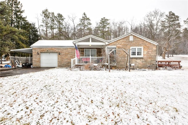 ranch-style home featuring a garage, driveway, a porch, and a carport