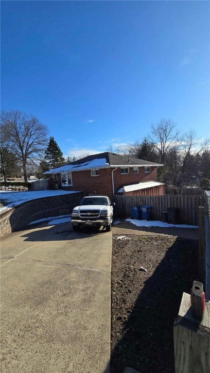 view of side of property featuring fence