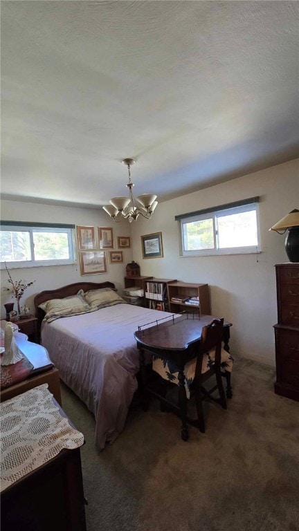 bedroom with a textured ceiling and dark carpet