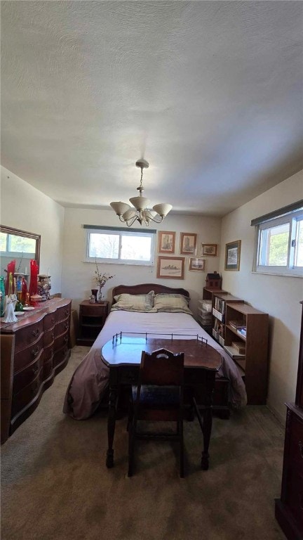 bedroom with ceiling fan, multiple windows, dark carpet, and a textured ceiling