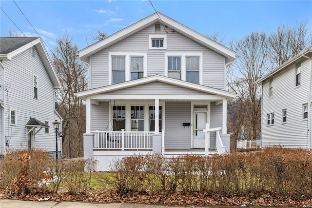 american foursquare style home featuring a porch