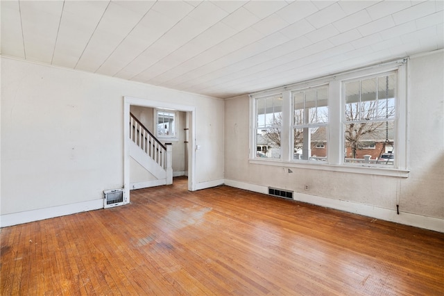 interior space featuring wood finished floors, visible vents, and stairs