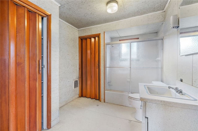 bathroom featuring bath / shower combo with glass door, visible vents, toilet, ornamental molding, and vanity