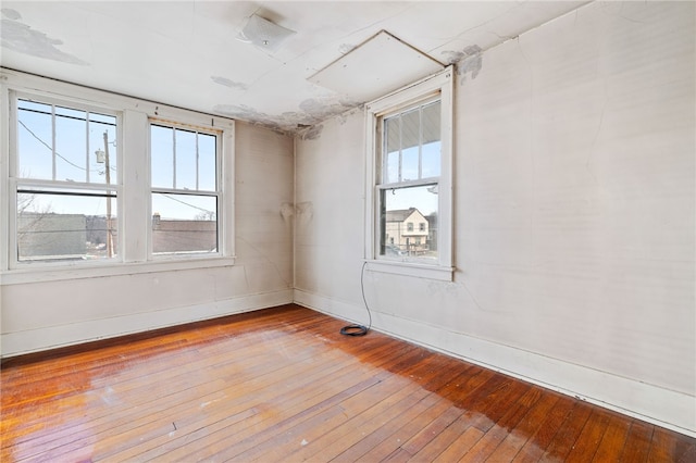 empty room featuring baseboards and wood finished floors