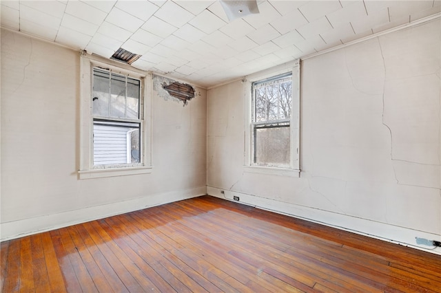 empty room featuring baseboards and wood finished floors