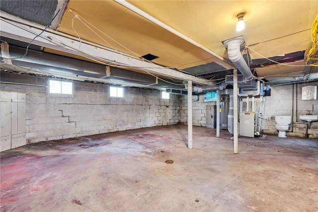 basement featuring heating unit and a sink