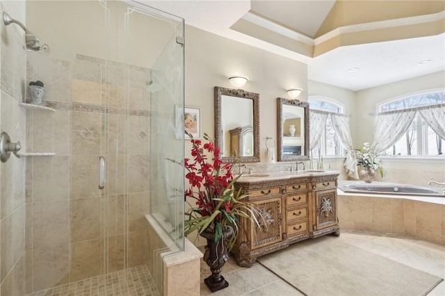 full bath with a garden tub, double vanity, a stall shower, a sink, and tile patterned flooring