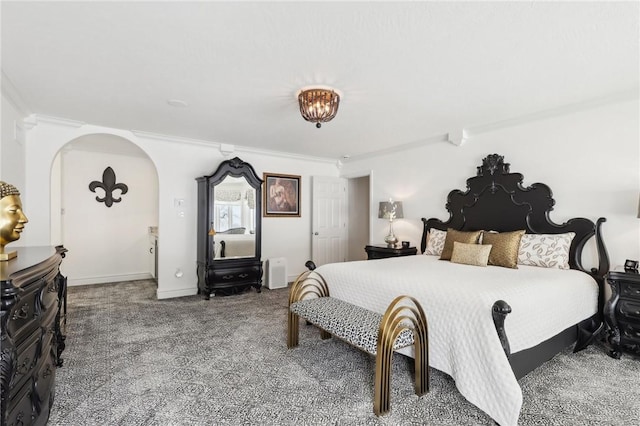 carpeted bedroom featuring ornamental molding and baseboards