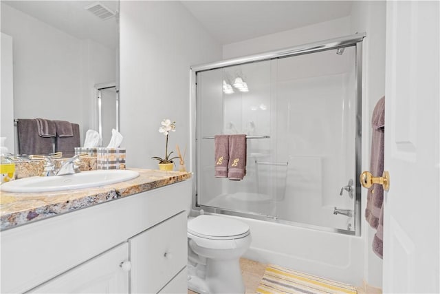 bathroom featuring tile patterned flooring, toilet, bath / shower combo with glass door, vanity, and visible vents