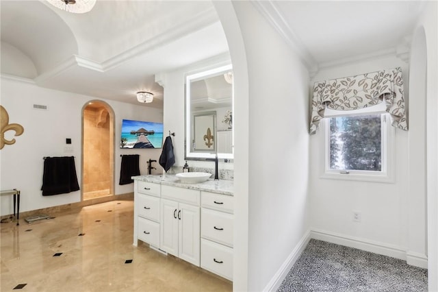 bathroom with ornamental molding, vanity, visible vents, and baseboards