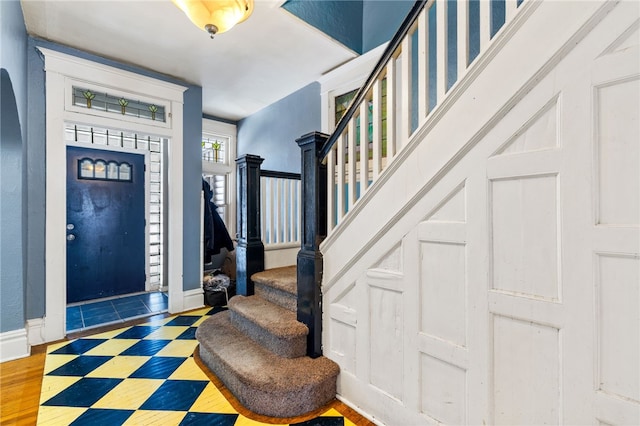 foyer with stairs and baseboards