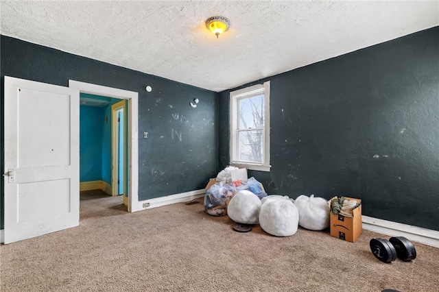 interior space with baseboards and a textured ceiling