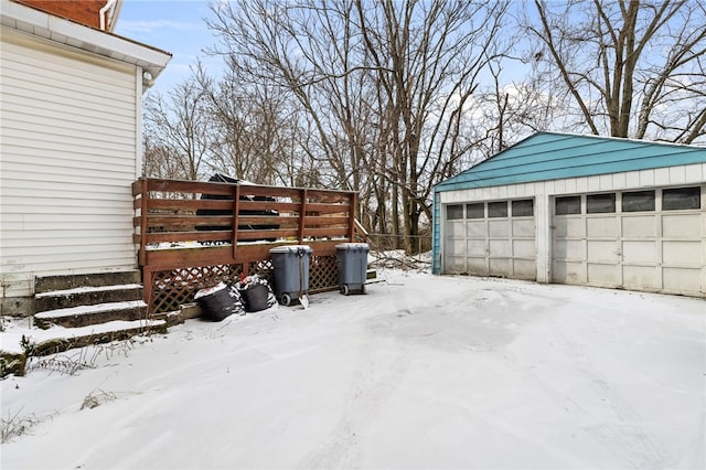 yard covered in snow with an outbuilding and a detached garage