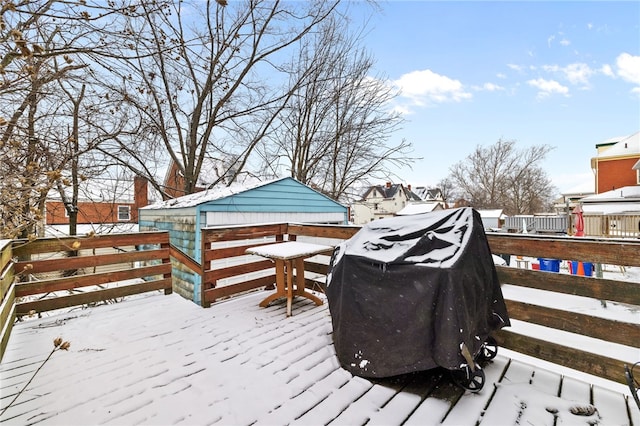 snow covered deck featuring a grill