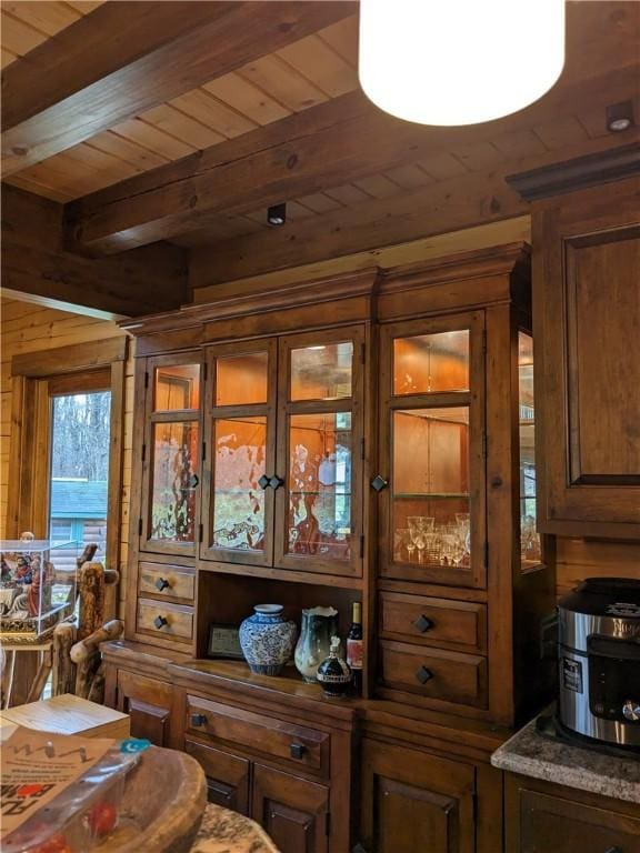 interior details featuring wood ceiling, beamed ceiling, and wood walls