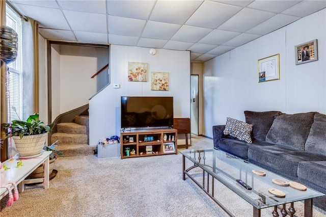 living room with carpet, stairway, and a drop ceiling