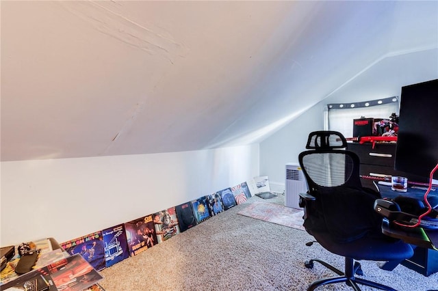 carpeted office featuring vaulted ceiling