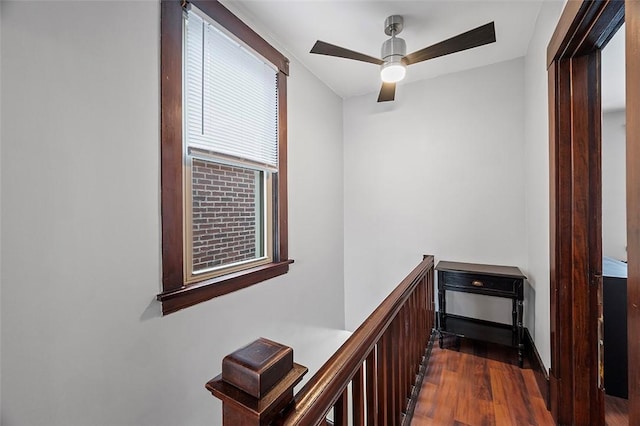 hallway featuring dark wood-type flooring and an upstairs landing