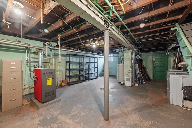 unfinished basement featuring gas water heater and independent washer and dryer