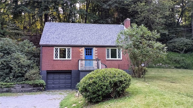 view of front of home with a shingled roof, a front yard, brick siding, and a chimney