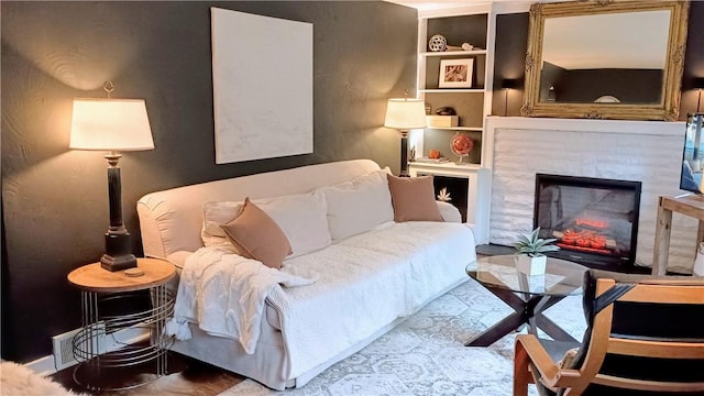 sitting room featuring a lit fireplace