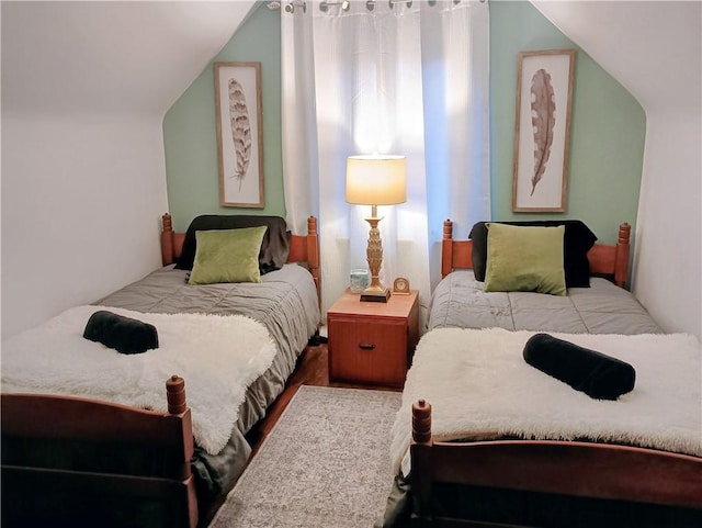 bedroom featuring vaulted ceiling and wood finished floors