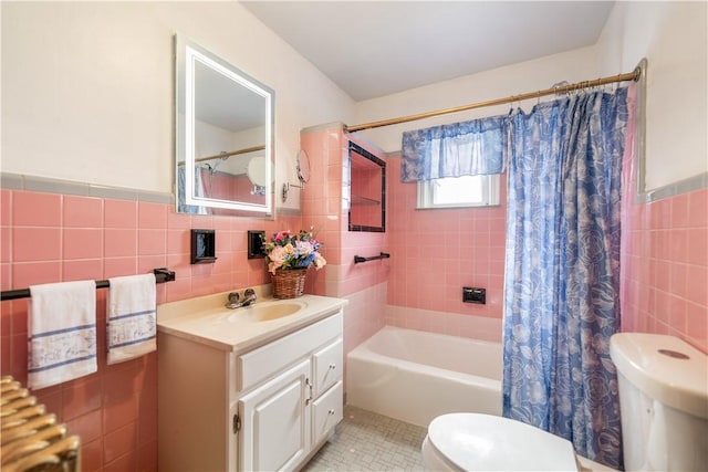 full bathroom with tile patterned flooring, toilet, vanity, tile walls, and shower / bath combination with curtain