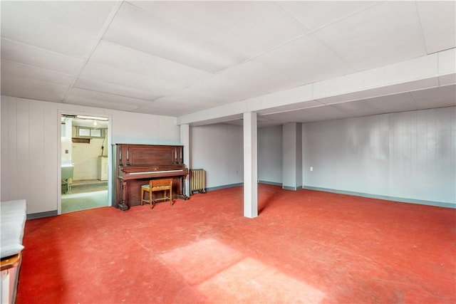 finished basement with washer / clothes dryer and radiator