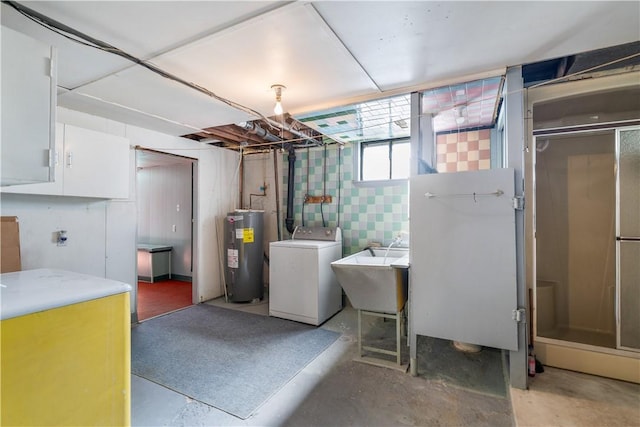 interior space with water heater, laundry area, a sink, and washer / dryer