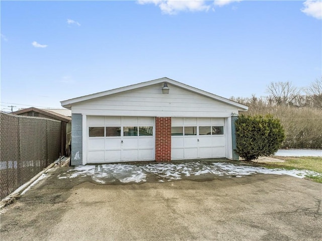 detached garage featuring fence