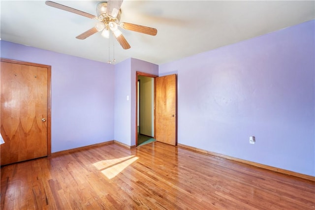 unfurnished bedroom featuring a ceiling fan, light wood-style flooring, and baseboards