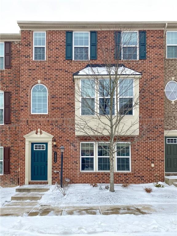 townhome / multi-family property featuring brick siding