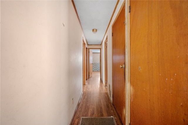 corridor featuring dark wood-style floors and visible vents