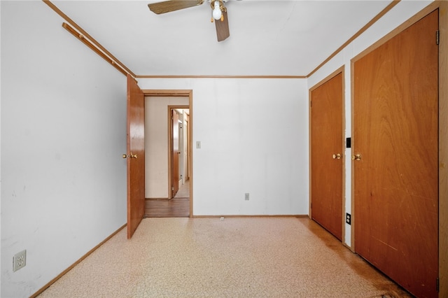 unfurnished bedroom with ornamental molding, a ceiling fan, and baseboards