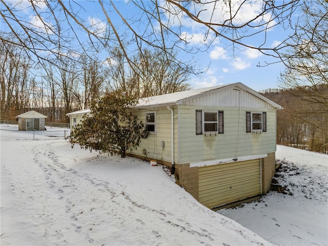 view of snow covered back of property