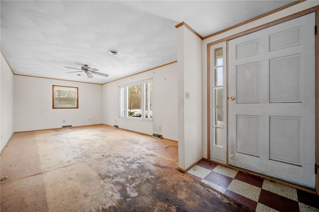 foyer with visible vents, crown molding, baseboards, and ceiling fan