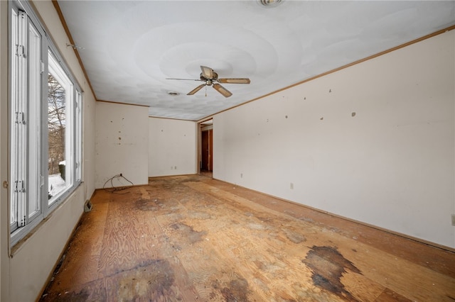 spare room featuring ceiling fan and crown molding